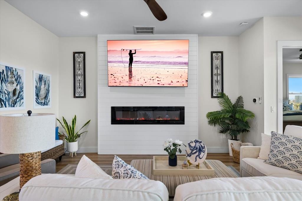 3344 Gulfview Drive Hernando Beach, FL 34607 - Photo 14 of 70 a living room with furniture a potted plant and a fireplace