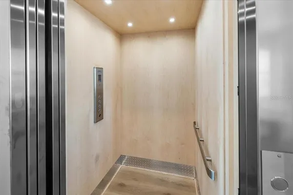 a view of storage and utility room with wooden floor