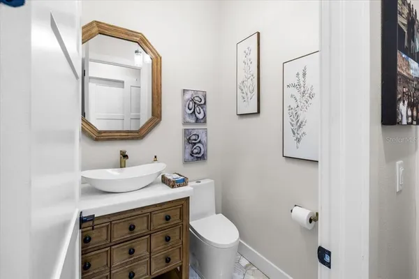 a bathroom with a sink a mirror a vanity and a shower