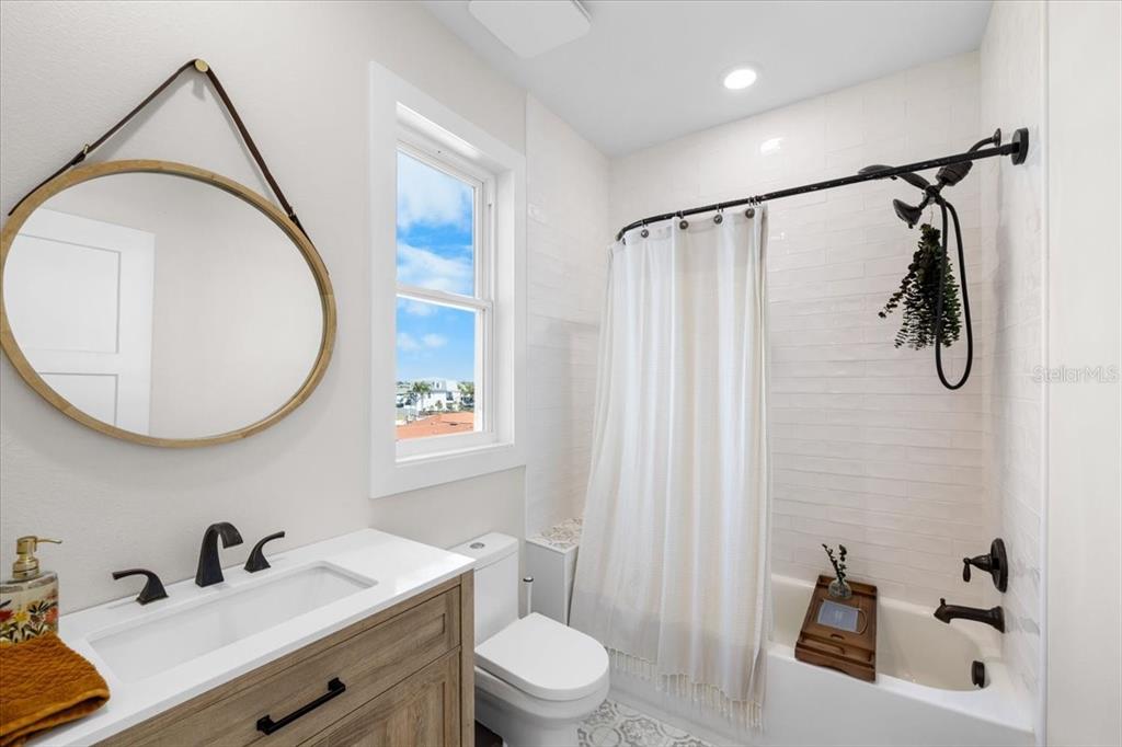3344 Gulfview Drive Hernando Beach, FL 34607 - Photo 50 of 70 a bathroom with a sink a mirror a vanity and a shower