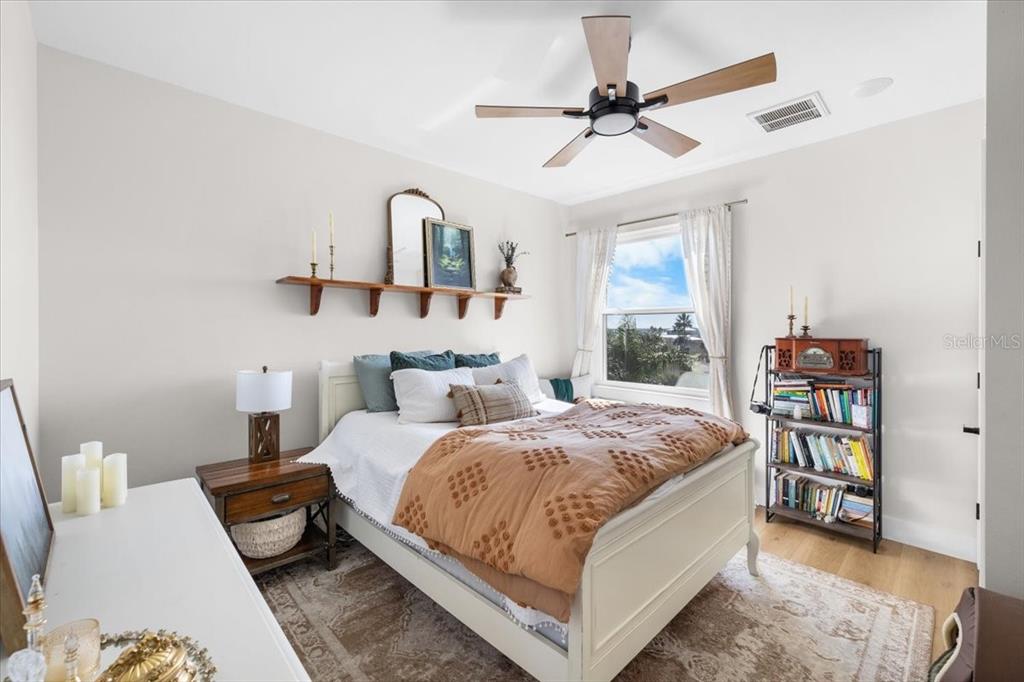 3344 Gulfview Drive Hernando Beach, FL 34607 - Photo 51 of 70 a bedroom with a bed a dresser and a chandelier