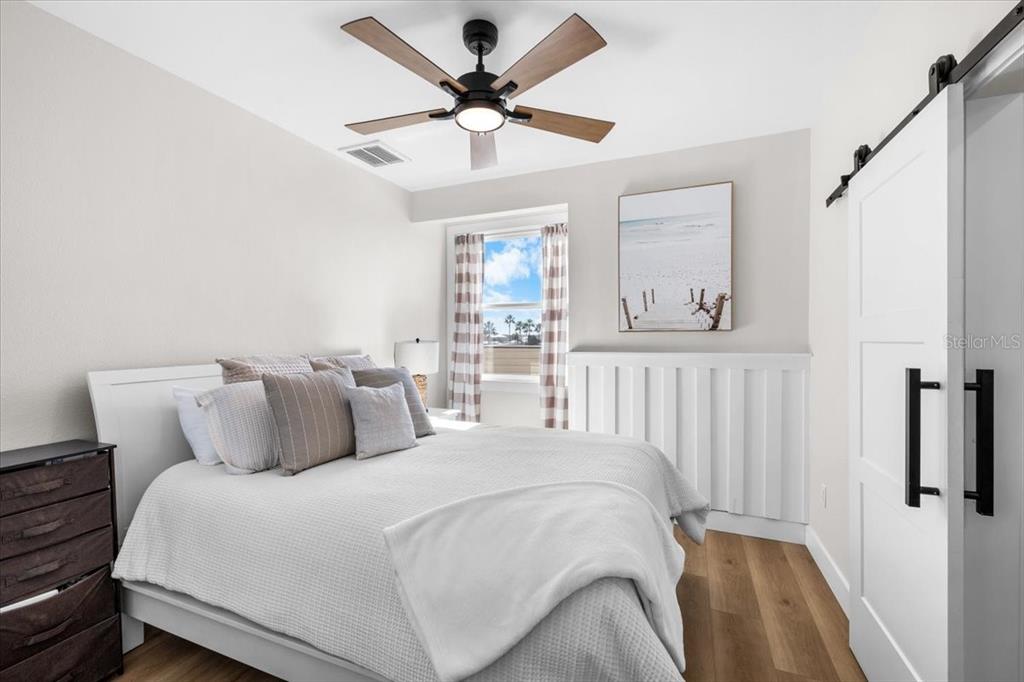 3344 Gulfview Drive Hernando Beach, FL 34607 - Photo 52 of 70 a bedroom with a large bed and a chandelier fan