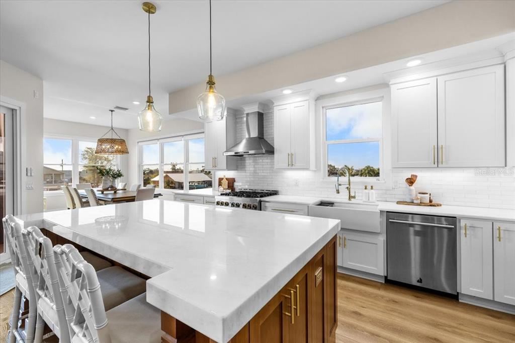 3344 Gulfview Drive Hernando Beach, FL 34607 - Photo 6 of 70 a large kitchen with kitchen island a stove a sink a center island and a wooden floor
