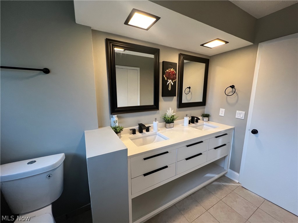 7475 Selwick Drive Parma, OH 44129 - Photo 21 of 29 Bathroom with tile flooring, toilet, double sink, and oversized vanity