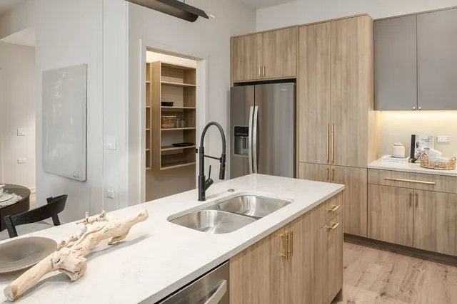 a kitchen with a sink and a refrigerator