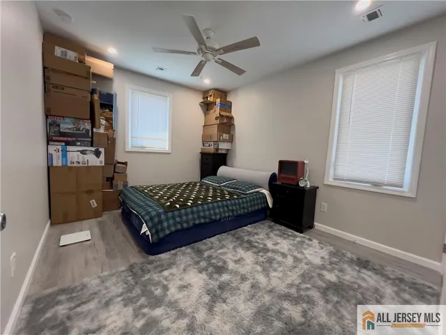 a bedroom with a bed window and dresser