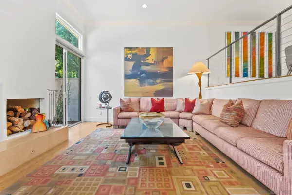 a living room with furniture and a painting on the wall