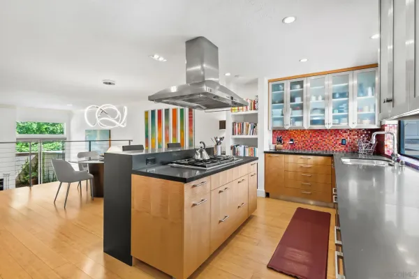 a view of kitchen with stainless steel appliances granite countertop cabinets and a window