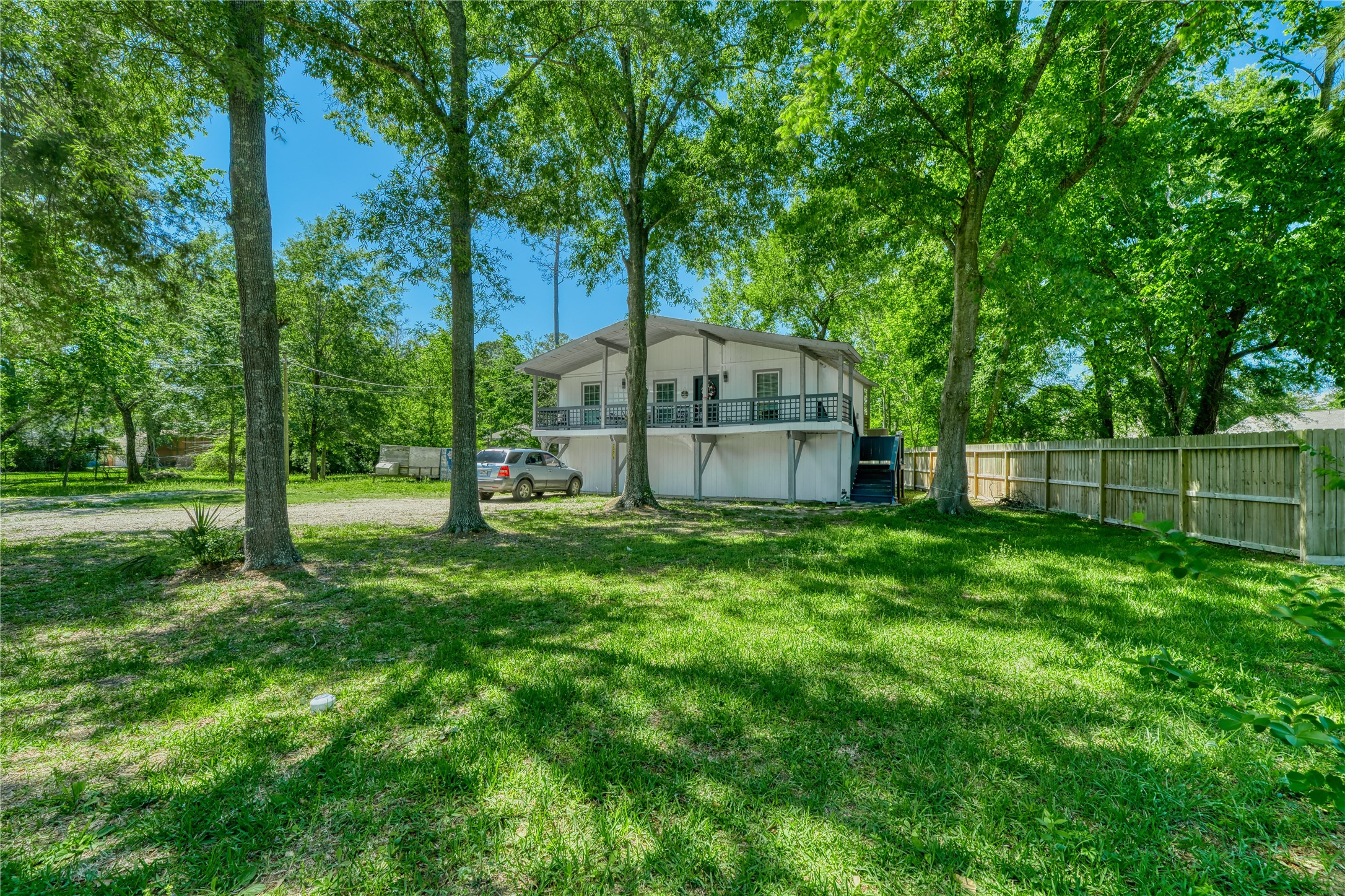 22418 East Shorewood Loop Houston, TX 77336 - Photo 3 of 20 a view of a backyard with a garden and trees