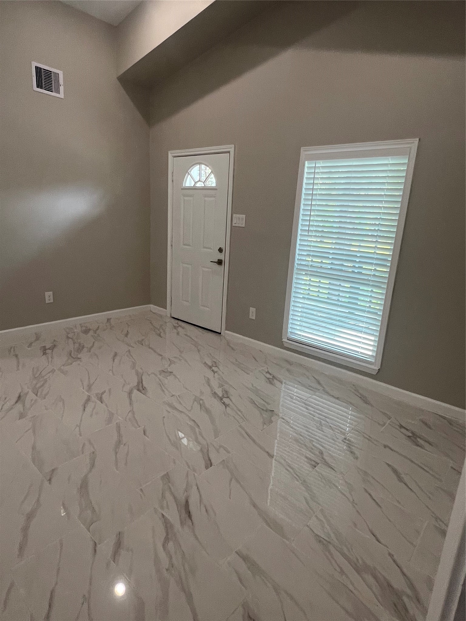 22418 East Shorewood Loop Houston, TX 77336 - Photo 7 of 20 a view of an empty room with wooden floor and a window