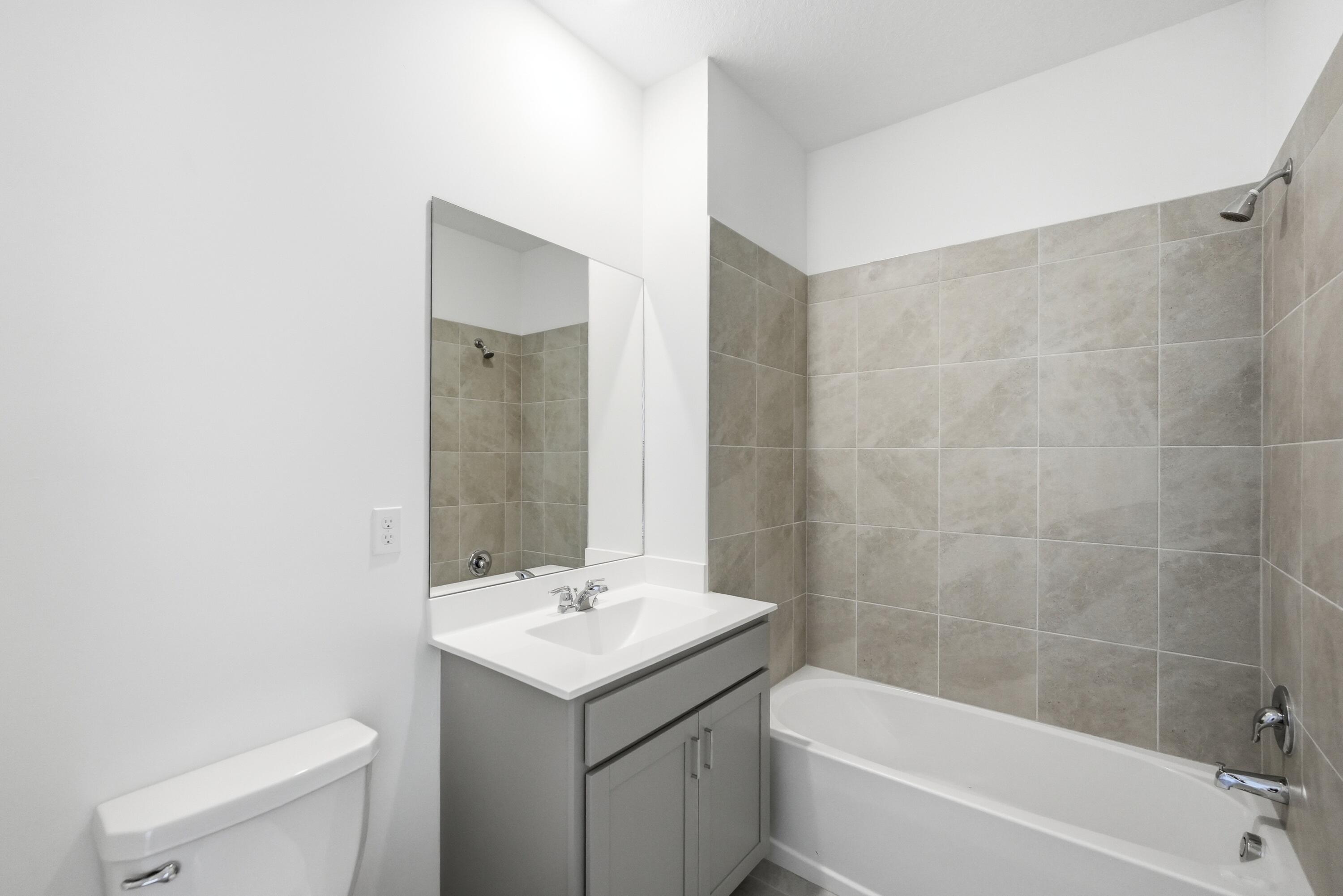 3736 Harborside Avenue Fort Pierce, FL 34946 - Photo 11 of 16 a bathroom with a sink toilet and shower