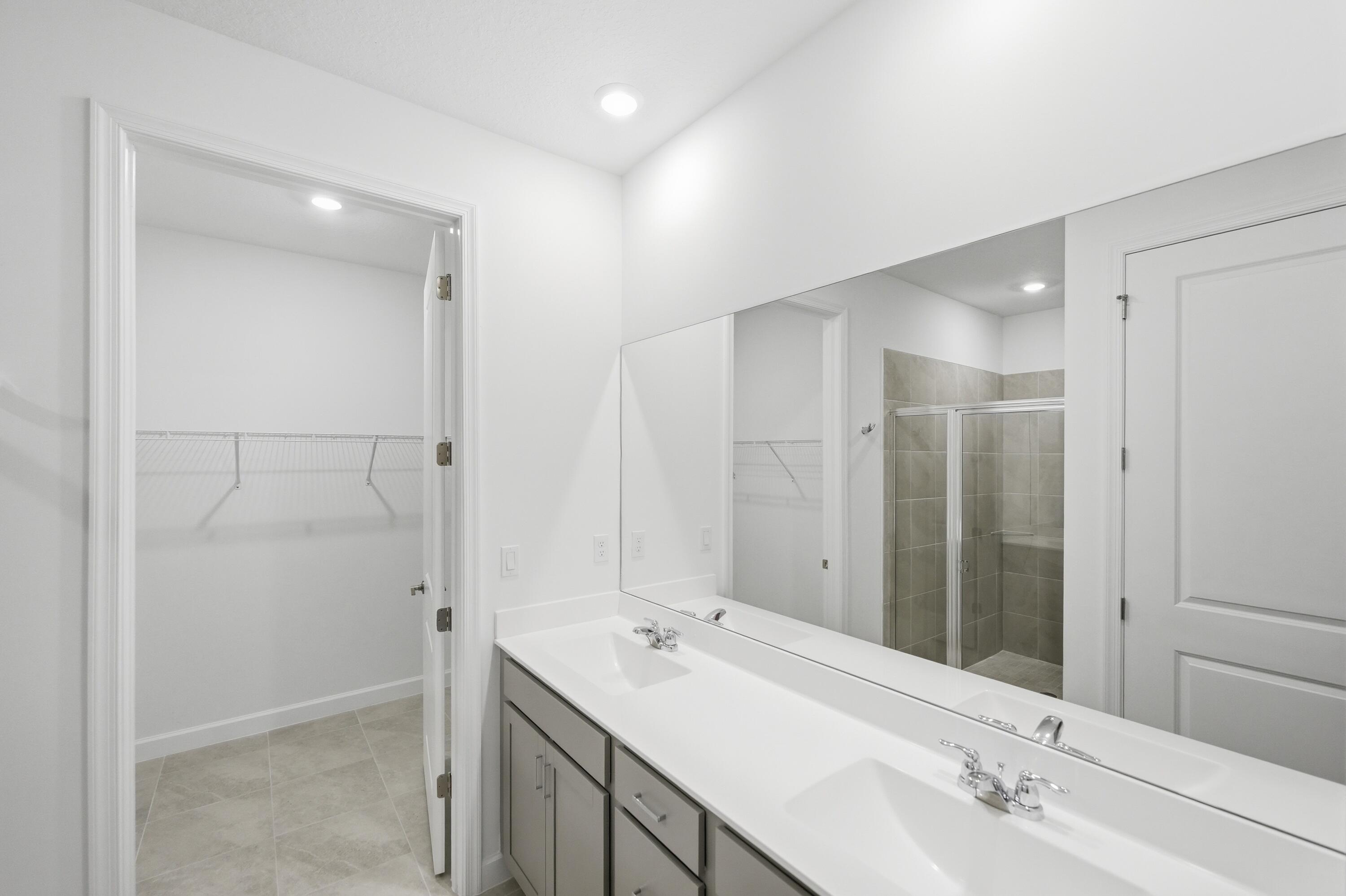 3736 Harborside Avenue Fort Pierce, FL 34946 - Photo 16 of 16 a bathroom with a double vanity sink and a mirror