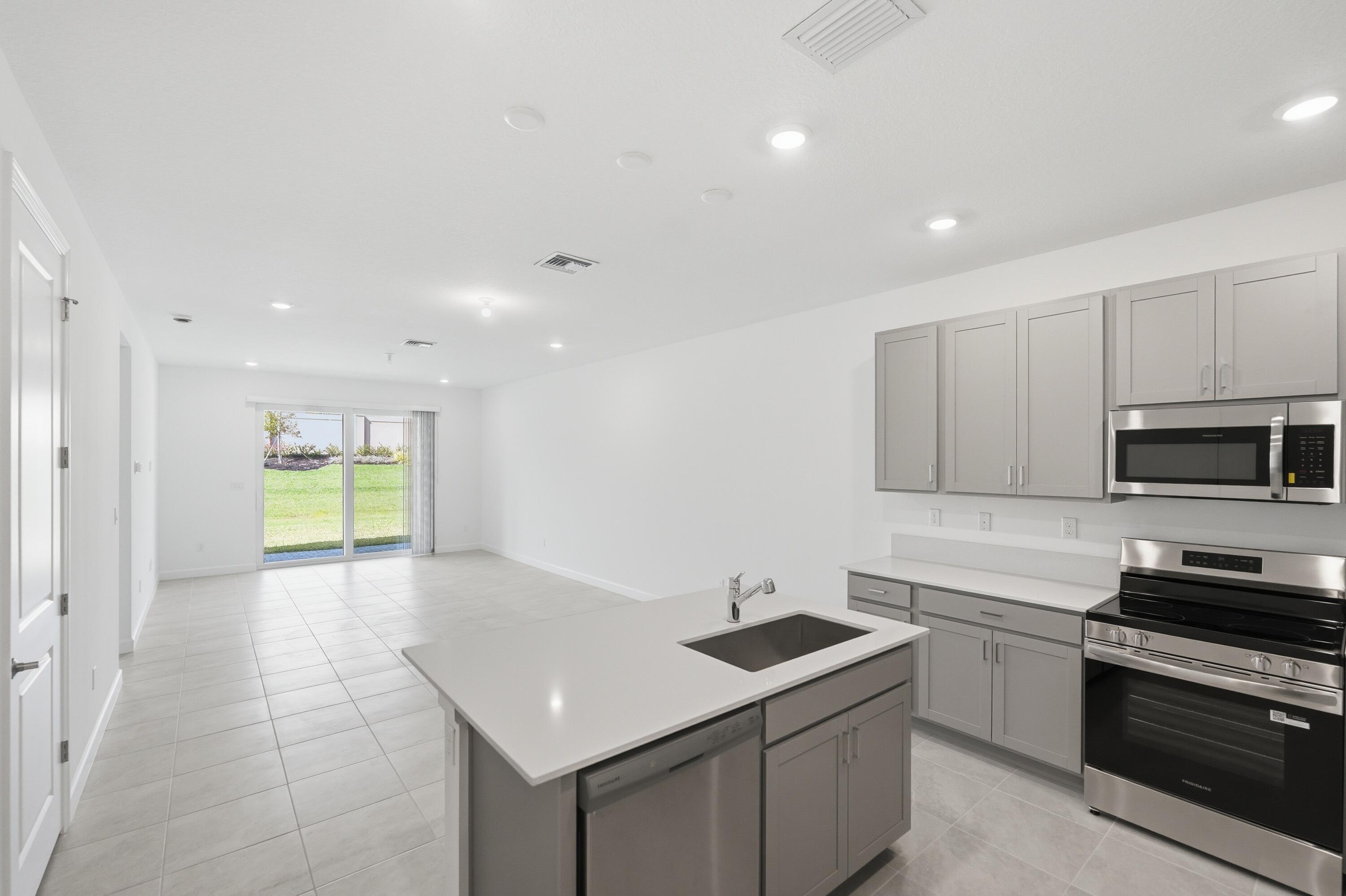 3736 Harborside Avenue Fort Pierce, FL 34946 - Photo 5 of 16 a kitchen that has a sink and a stove in it