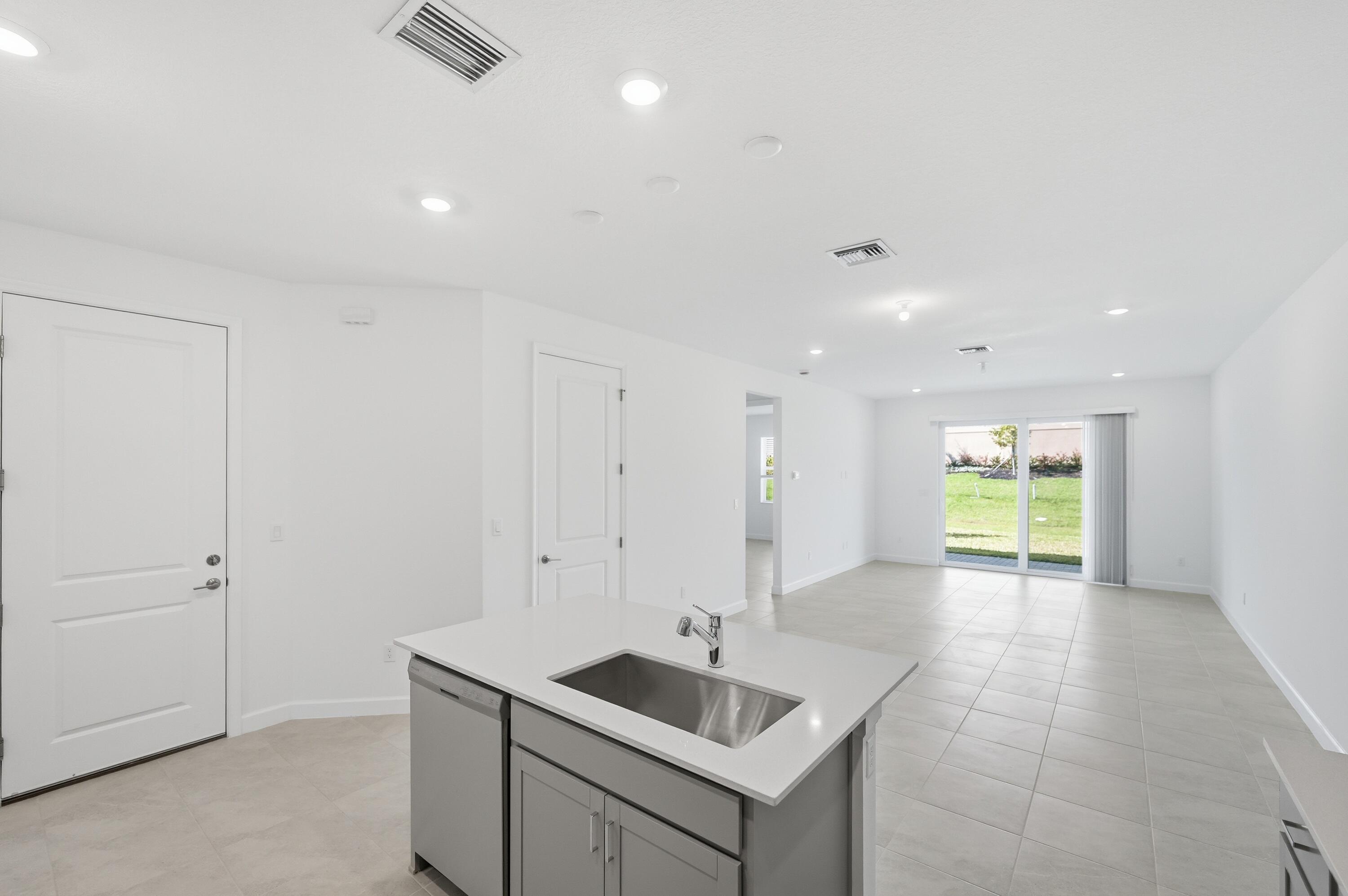 3736 Harborside Avenue Fort Pierce, FL 34946 - Photo 6 of 16 a view of kitchen with a sink dishwasher and fireplace