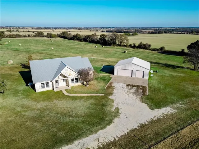 an aerial view of a house with a ocean view