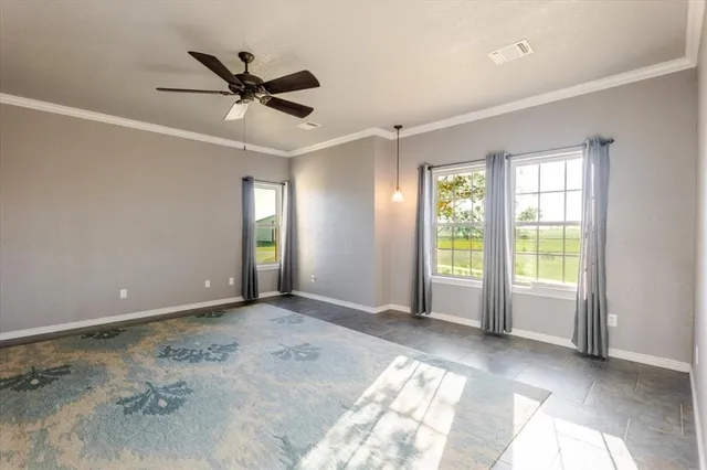 a view of a livingroom with a ceiling fan and window