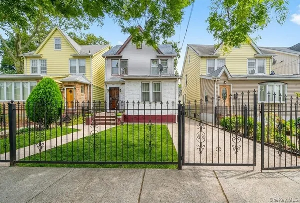a front view of a house with a garden and plants