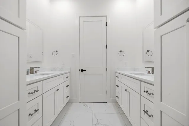 a spacious bathroom with a double vanity sink mirror and