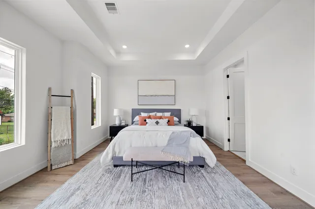 a bedroom with a bed and a large window