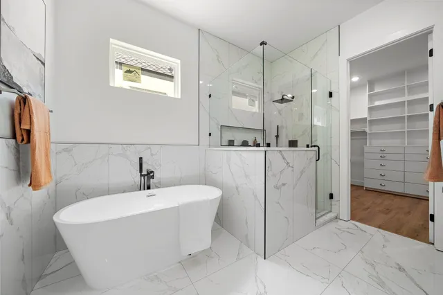 a bathroom with a bathtub and shower