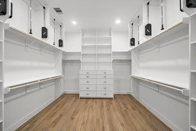 a view of an empty walk in closet with empty racks