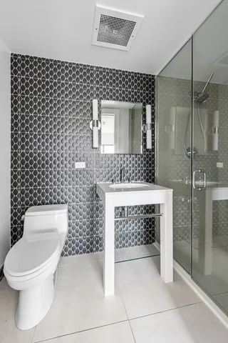 a spacious bedroom with a bed and glass window