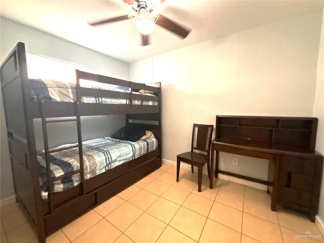 a bedroom with furniture and a air conditioner vent