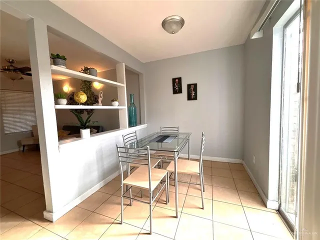 a view of a dining room with a table and chairs