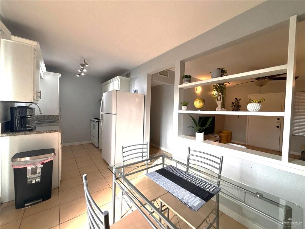 2428 Upas Avenue, Unit 3 McAllen, TX 78501 - Photo 7 of 14 a kitchen with a refrigerator and a stove top oven