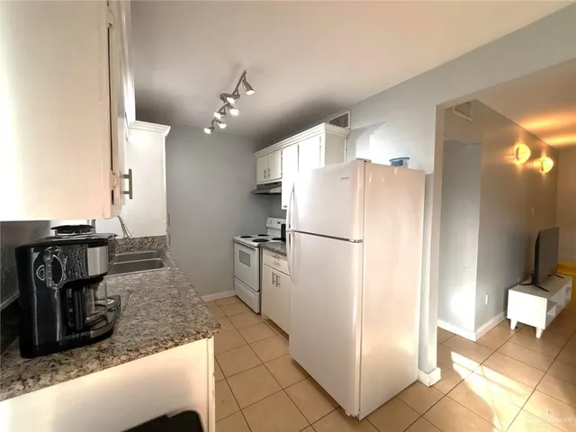 a kitchen with refrigerator and faucet