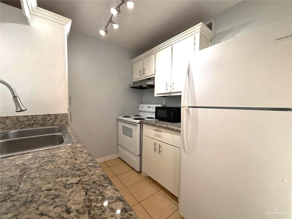 2428 Upas Avenue, Unit 3 McAllen, TX 78501 - Photo 10 of 14 a kitchen with a refrigerator and a stove top oven