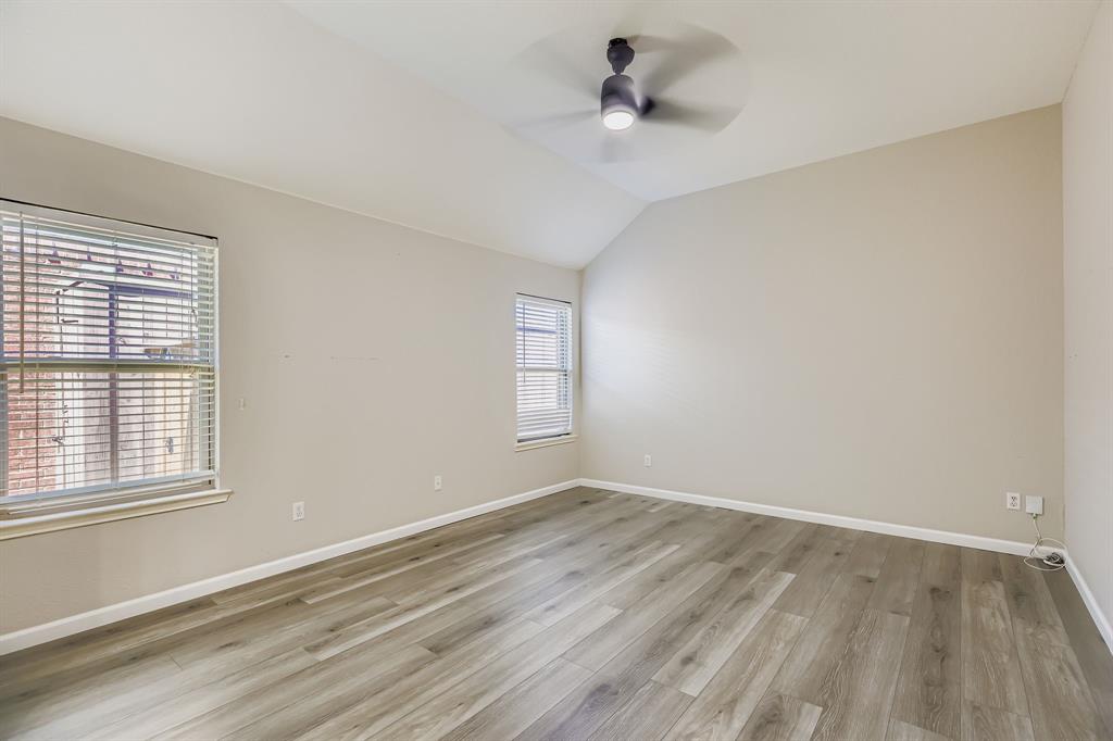 5452 Buckskin Drive The Colony, TX 75056 - Photo 20 of 31 Unfurnished room with light wood-type flooring, lofted ceiling, and ceiling fan