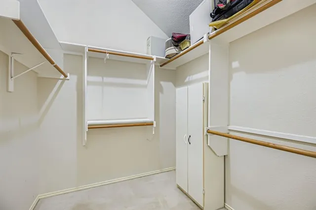 a view of a patio with table and chairs with wooden fence
