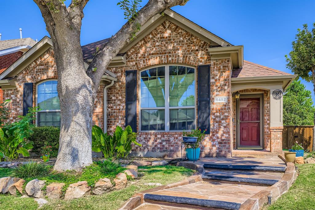 5452 Buckskin Drive The Colony, TX 75056 - Photo 4 of 31 View of front of home with brick siding and a shingled roof