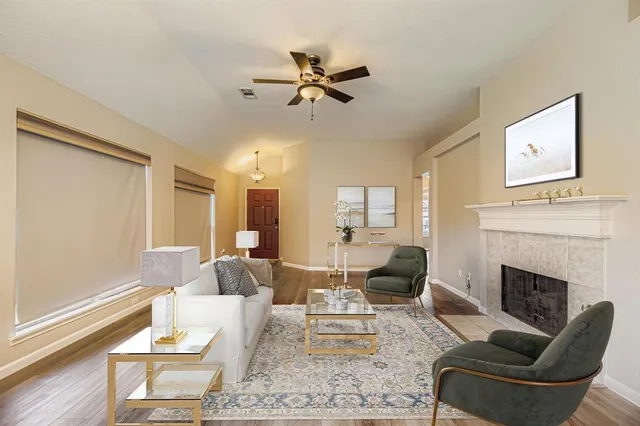 a living room with furniture fireplace and a window
