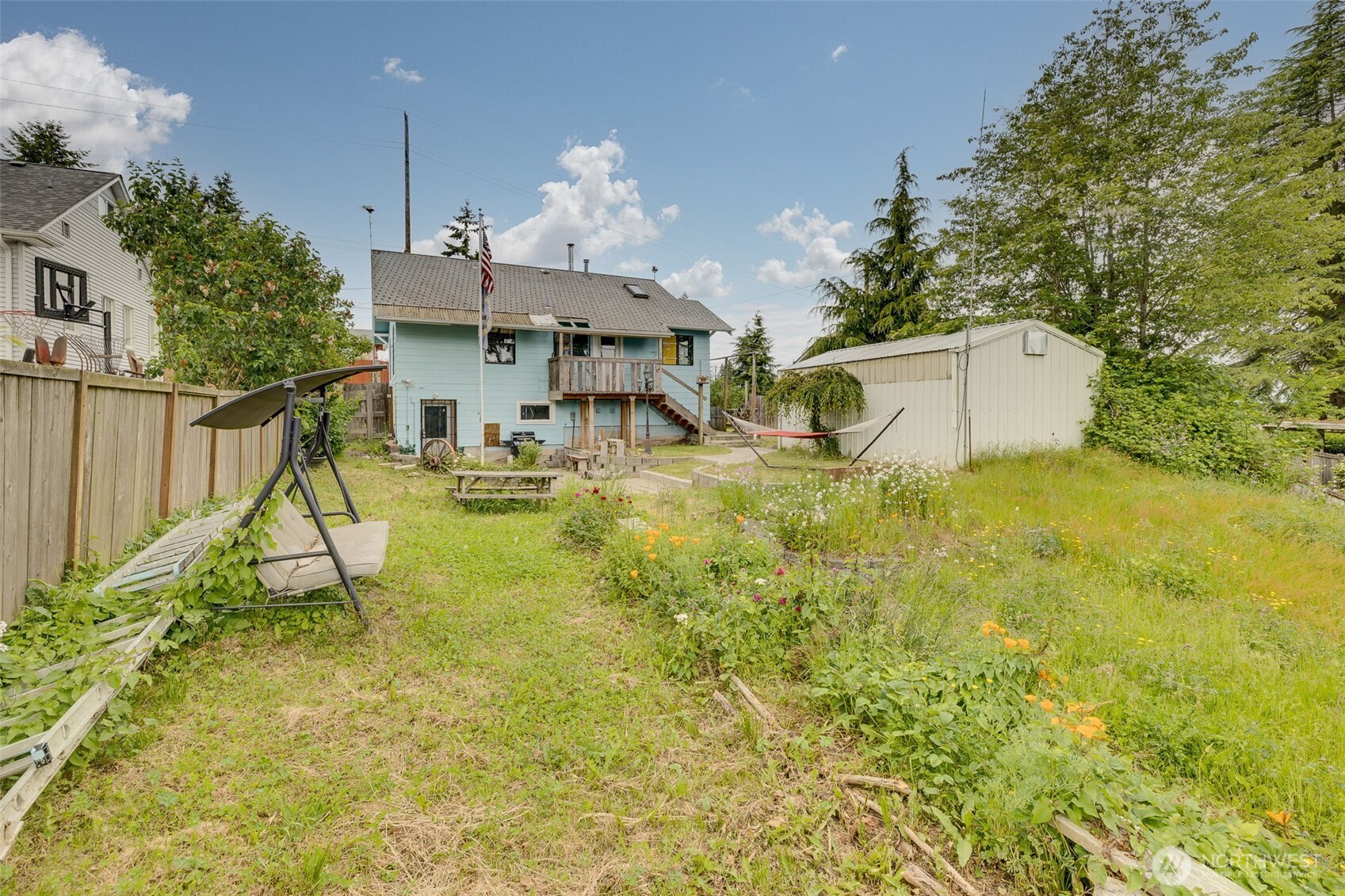 2310 Lowell Road Everett, WA 98203 - Photo 24 of 34 a backyard of a house with table and chairs