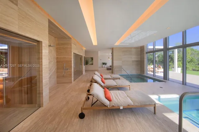 a living room with furniture a wooden floor and next to windows