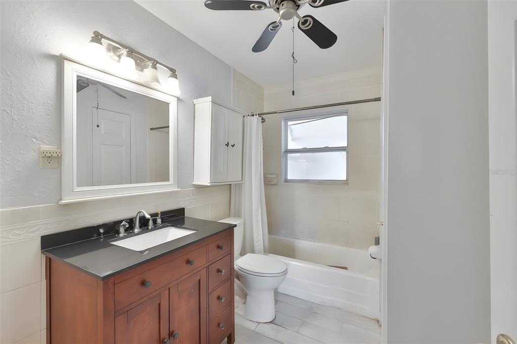 14451 Highland Road Wimauma, FL 33598 - Photo 66 of 80 a bathroom with a sink a toilet a mirror and shower
