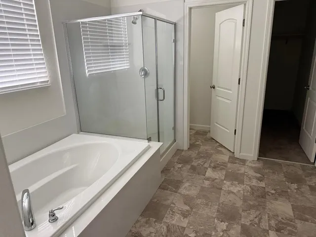 a bathroom with a tub and shower