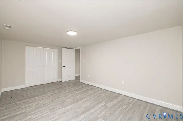 a view of a kitchen with a sink and dishwasher a refrigerator with wooden floor