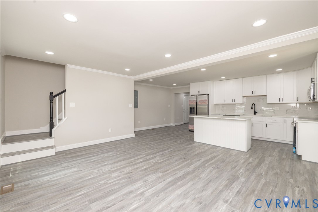 1103 Burnside Street Hopewell, VA 23860 - Photo 43 of 44 a large kitchen with stainless steel appliances kitchen island a large counter top and a wooden floors