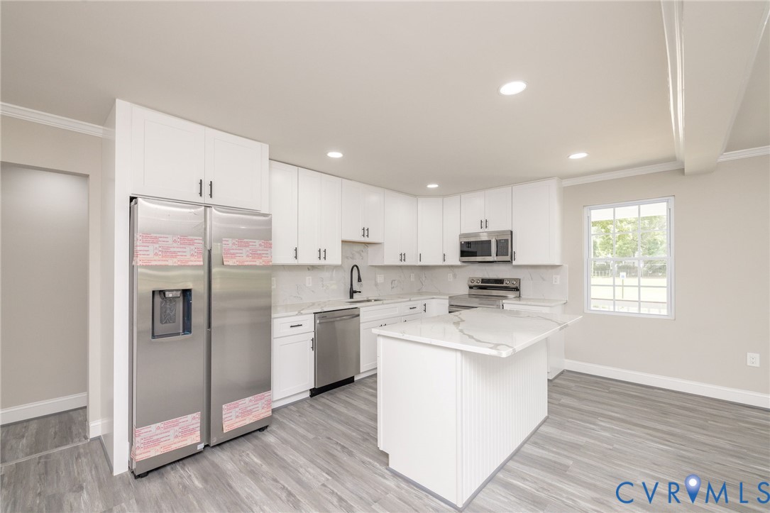 1103 Burnside Street Hopewell, VA 23860 - Photo 15 of 44 a kitchen with stainless steel appliances granite countertop a refrigerator a oven a sink a stove and white cabinets with wooden floor