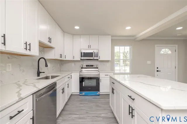 a kitchen with a sink stove top oven and cabinets