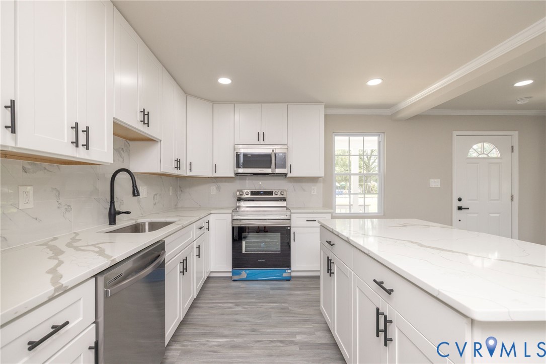 1103 Burnside Street Hopewell, VA 23860 - Photo 16 of 44 a kitchen with a sink stove top oven and cabinets