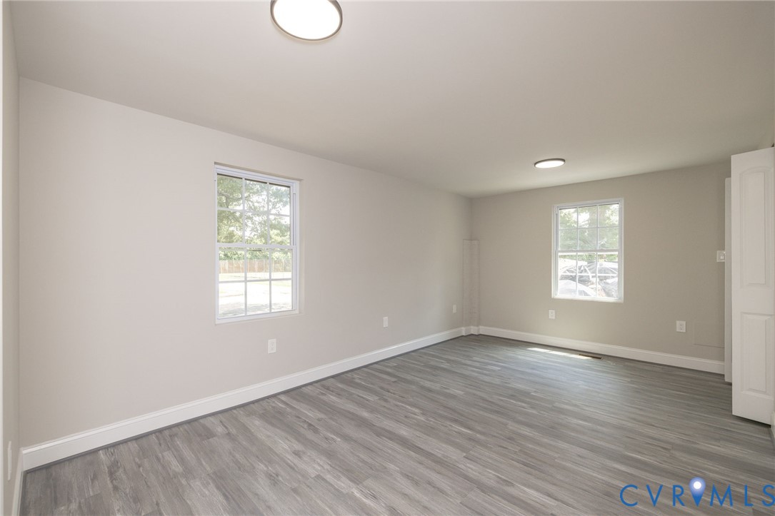 1103 Burnside Street Hopewell, VA 23860 - Photo 20 of 44 an empty room with wooden floor and windows