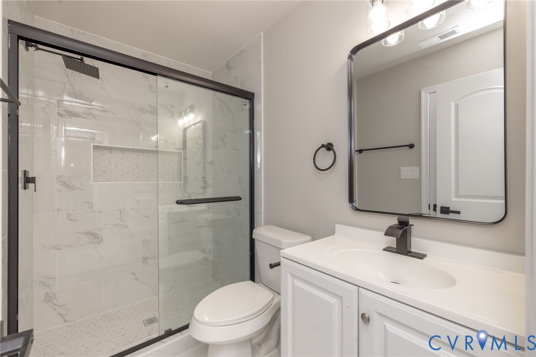 1103 Burnside Street Hopewell, VA 23860 - Photo 28 of 44 a bathroom with a sink toilet a mirror and shower