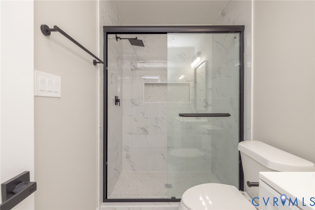 1103 Burnside Street Hopewell, VA 23860 - Photo 29 of 44 a bathroom with a granite countertop toilet and a shower