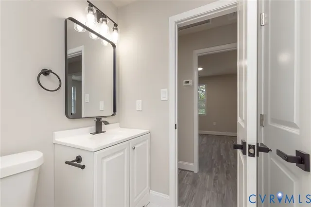 a bathroom with a sink vanity and a mirror