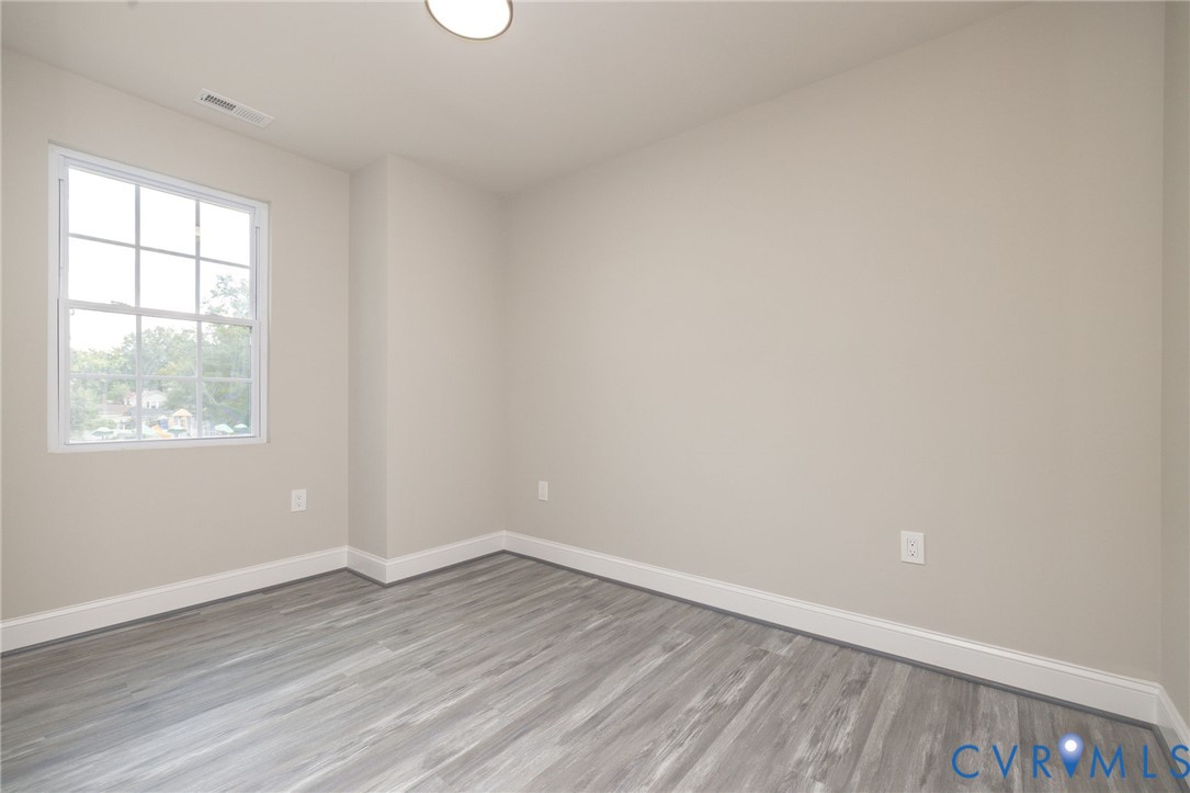 1103 Burnside Street Hopewell, VA 23860 - Photo 31 of 44 wooden floor in an empty room with a window