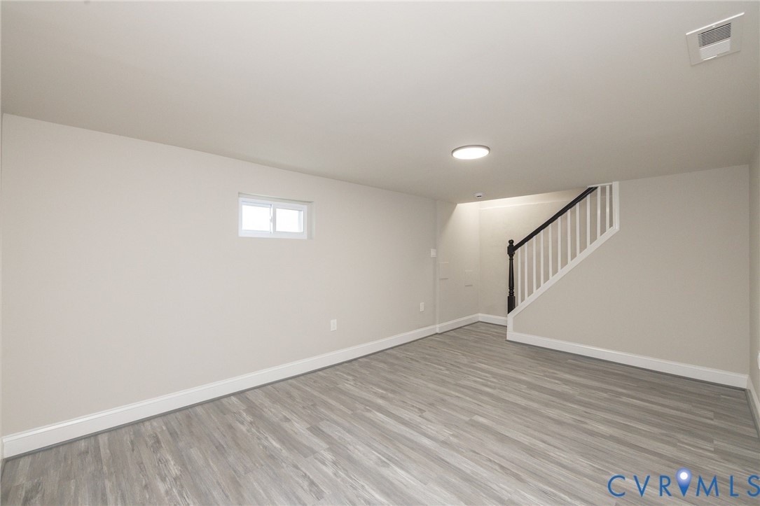 1103 Burnside Street Hopewell, VA 23860 - Photo 9 of 44 a view of an empty room with wooden floor and a window